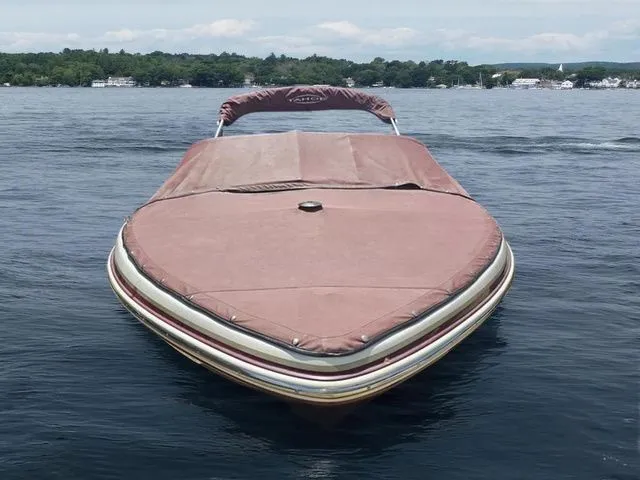 Slide: The Image of 2013 Tahoe Q5i boat with cover on a calm lake. - 5