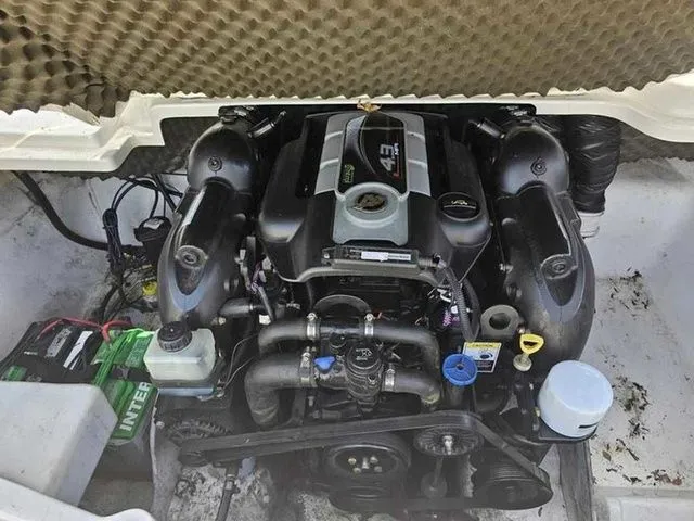 Slide: The Image of Engine compartment of a 2013 Tahoe Q5i boat, featuring a well-maintained motor. - 6