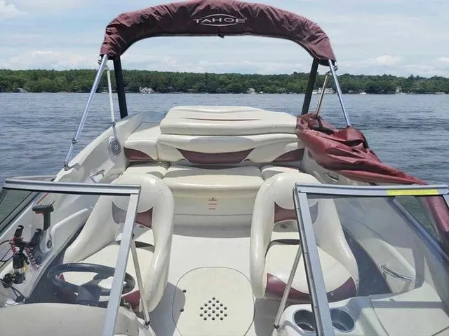 Slide: The Image of 2013 Tahoe Q5i boat interior on a lake, featuring seating and canopy. - 9