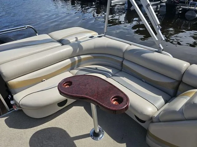 Slide: The Image of Luxurious seating area on a 2012 South Bay 522 CR pontoon boat by the water. - 11