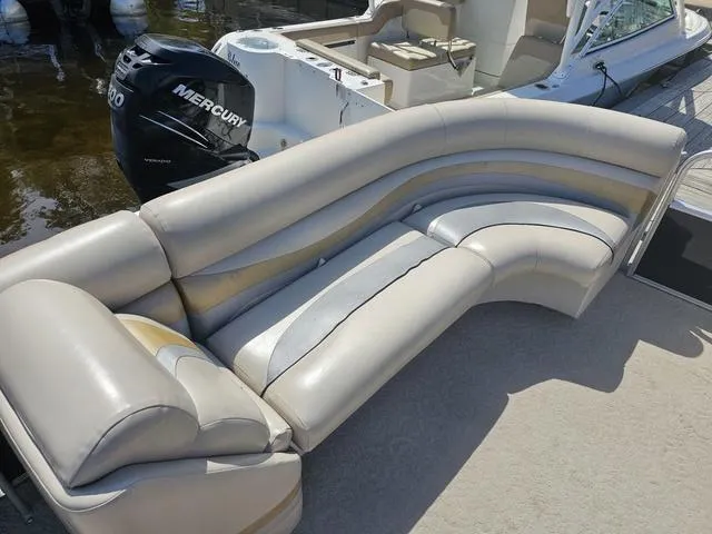 Slide: The Image of Luxurious seating on a 2012 South Bay 522 CR pontoon boat, featuring a Mercury outboard motor. - 6