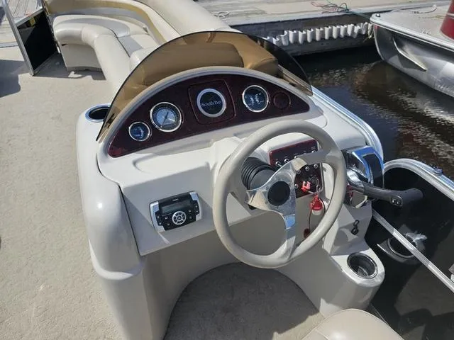Slide: The Image of 2012 South Bay 522 CR boat dashboard with steering wheel and gauges. - 9