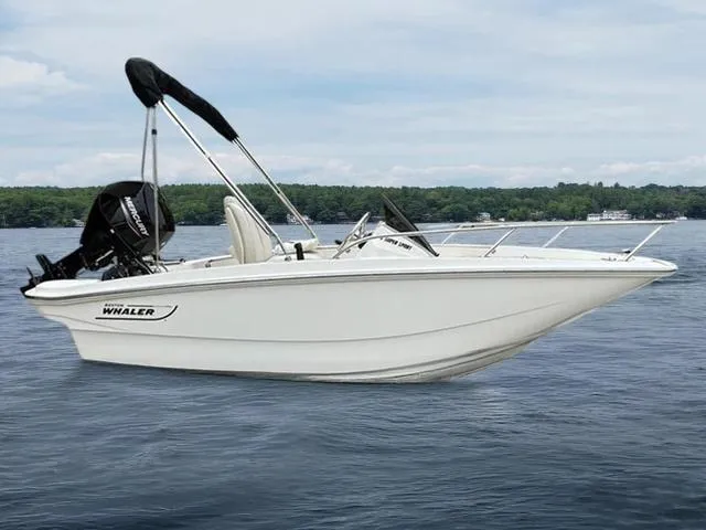 Slide: The Image of 2024 Boston Whaler 130 Super Sport boat on calm water, featuring sleek design and modern features. - 5