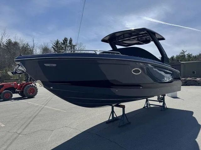 Slide: The Image of 2025 Chaparral 2870 SSX boat displayed on stands in a parking lot. - 7