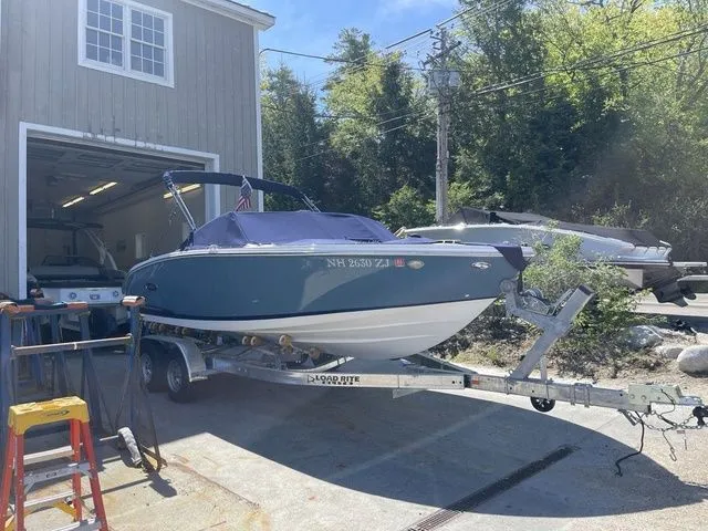 Slide: The Image of 2023 Cobalt CS22 boat on trailer outside garage, sunny day. - 16