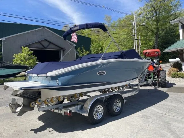 Slide: The Image of 2023 Cobalt CS22 boat on trailer, covered, outdoors, sunny day. - 18