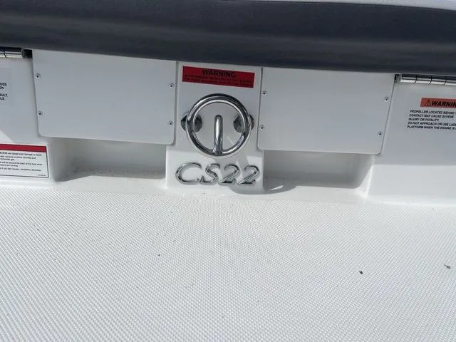 Slide: The Image of 2023 Cobalt CS22 boat stern with logo and warning labels. - 21