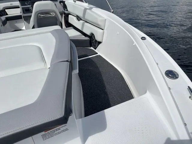 Slide: The Image of 2023 Cobalt CS22 boat interior with white seating and sleek design on the water. - 22