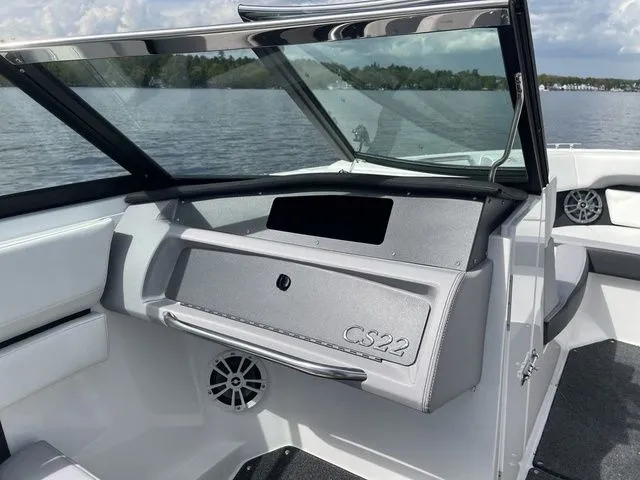 Slide: The Image of 2023 Cobalt CS22 boat interior with open windshield, showcasing sleek design and lake view. - 33