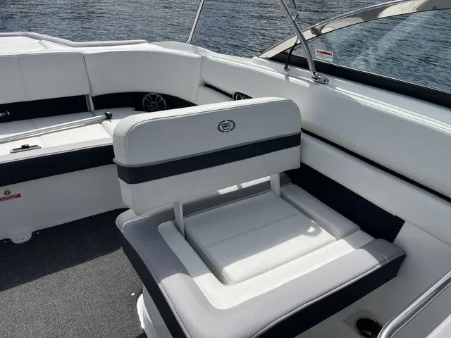 Slide: The Image of 2023 Cobalt CS22 boat interior with white seating, black accents, and water in the background. - 34