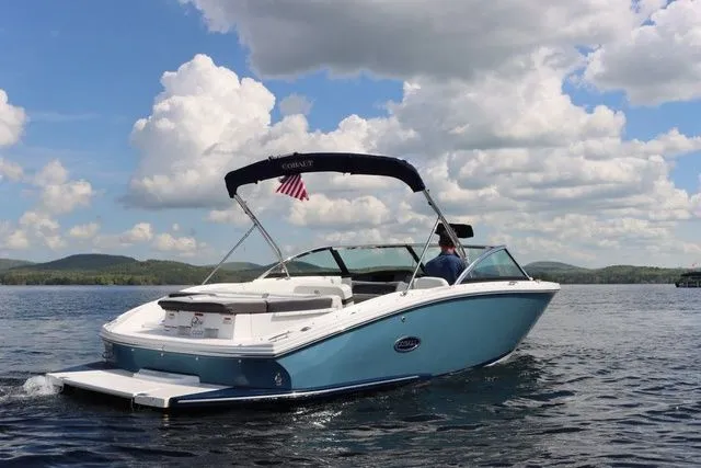 Slide: The Image of 2023 Cobalt CS22 boat cruising on a lake under a cloudy sky. - 6