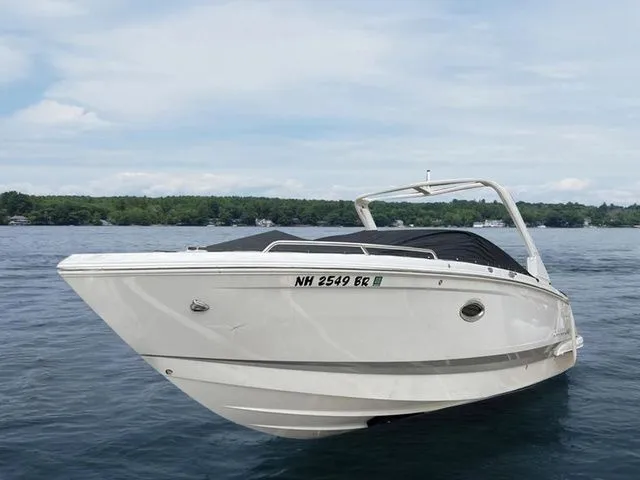 Slide: The Image of 2019 Chaparral 277SX boat on a calm lake with a scenic background. - 1