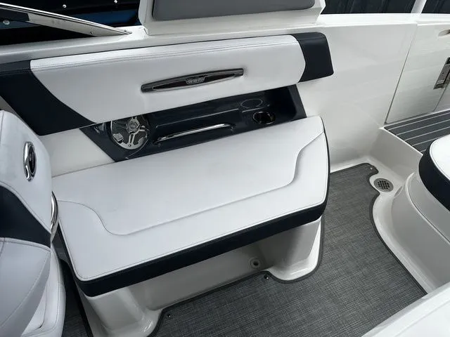 Slide: The Image of 2019 Chaparral 277SX boat interior with white seating and sleek design. - 12