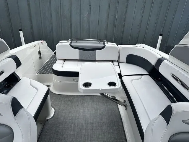 Slide: The Image of 2019 Chaparral 277SX boat interior with white seating and table. - 14