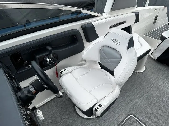 Slide: The Image of 2019 Chaparral 277SX boat interior with white captain's seat and steering wheel. - 16