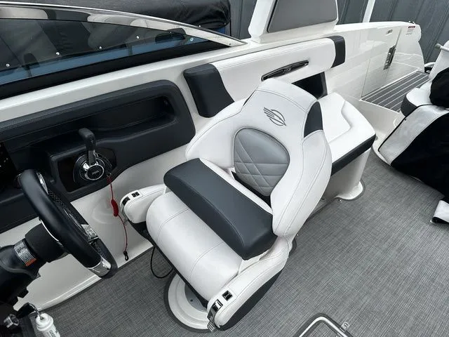 Slide: The Image of 2019 Chaparral 277SX boat interior with white captain's seat and steering wheel. - 17