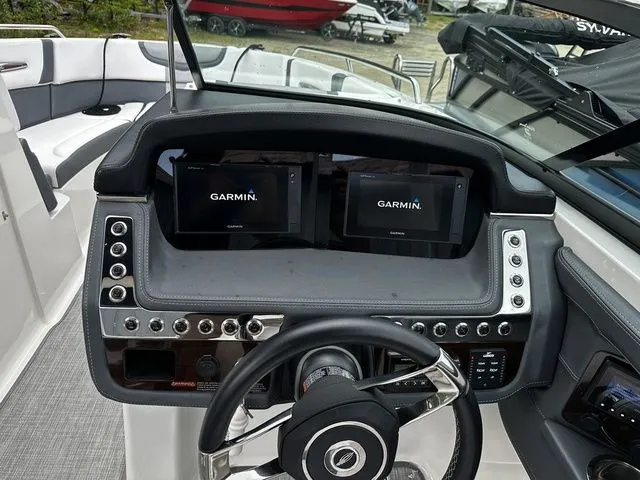 Slide: The Image of 2019 Chaparral 277SX boat dashboard with Garmin displays and steering wheel. - 18