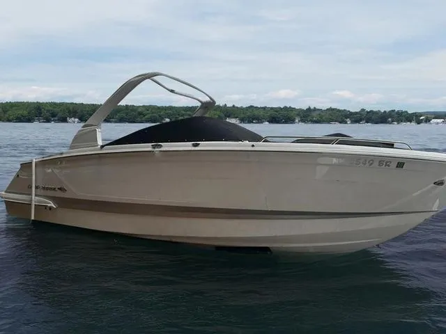 Slide: The Image of 2019 Chaparral 277SX boat on a calm lake with scenic background. - 2