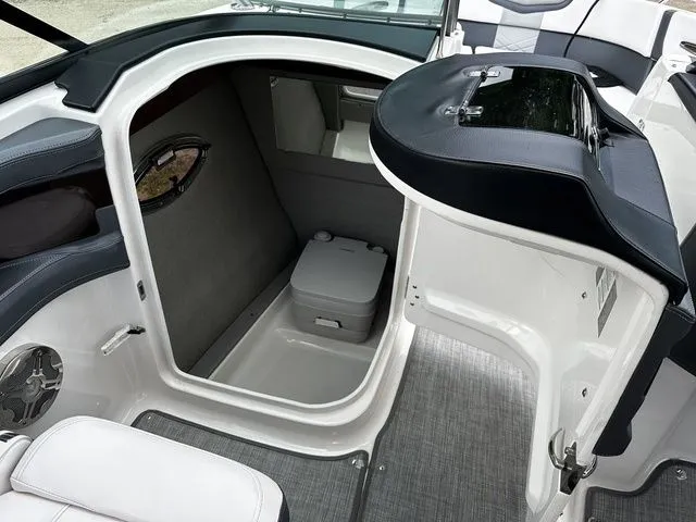 Slide: The Image of 2019 Chaparral 277SX boat interior with compact cabin and portable toilet. - 22