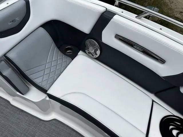 Slide: The Image of 2019 Chaparral 277SX boat interior with white and gray seating, speaker, and cup holder. - 25