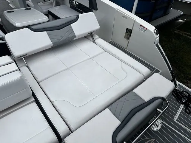 Slide: The Image of 2019 Chaparral 277SX boat interior with white and gray seating and table. - 9