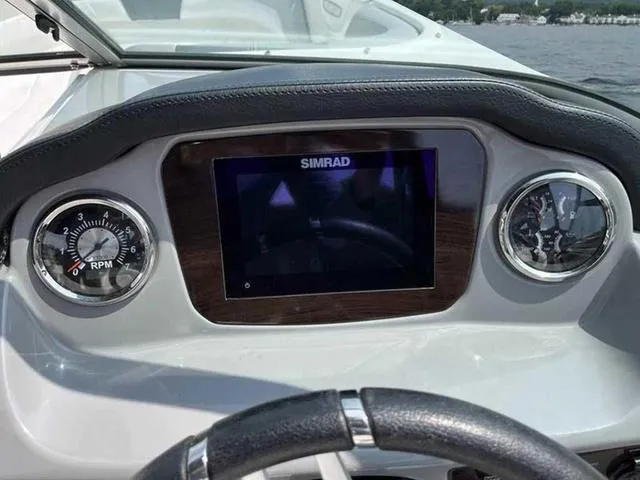 Slide: The Image of Dashboard of 2021 Chaparral 21 SSI Sport boat with Simrad display and RPM gauge. - 14