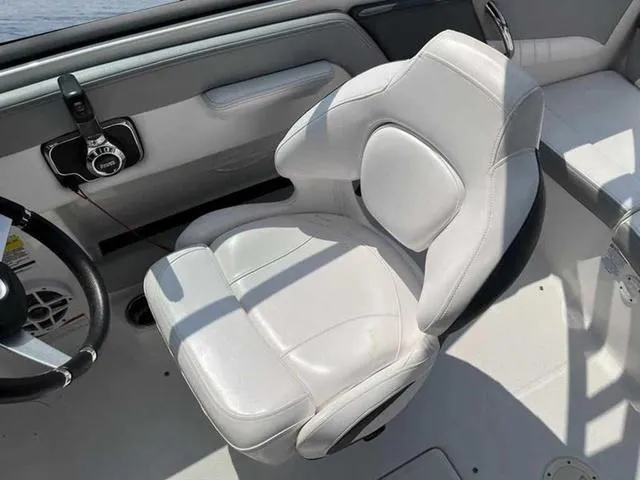 Slide: The Image of 2021 Chaparral 21 SSI Sport boat interior with white captain's seat and steering wheel. - 16