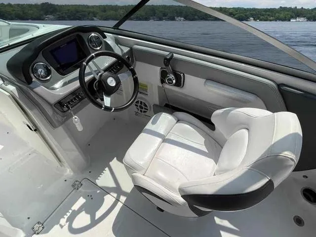 Slide: The Image of Interior of 2021 Chaparral 21 SSI Sport boat with steering wheel and seating. - 20