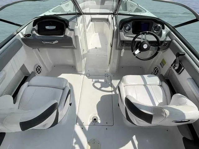 Slide: The Image of 2021 Chaparral 21 SSI Sport boat interior with dual seating and modern dashboard. - 24