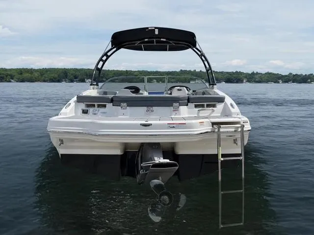Slide: The Image of 2021 Chaparral 21 SSI Sport boat on calm lake with ladder and canopy. - 4