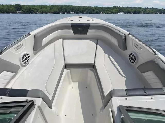 Slide: The Image of 2021 Chaparral 21 SSI Sport boat interior with spacious seating on a calm lake. - 7