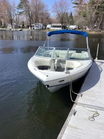 Slide: The Image of 2016 Cobalt 200S boat docked on a calm lake with trees in the background. - 1