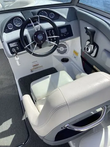 Slide: The Image of 2016 Cobalt 200S boat cockpit with steering wheel, gauges, and white captain's chair. - 10