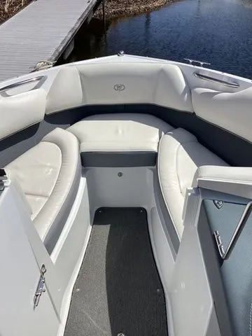 Slide: The Image of 2016 Cobalt 200S boat interior with white seating and gray accents near a dock. - 13