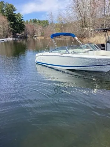 Slide: The Image of 2016 Cobalt 200S boat on a calm lake with trees in the background. - 17