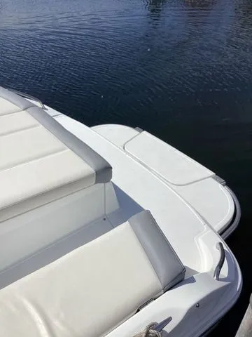 Slide: The Image of 2016 Cobalt 200S boat with white seating, docked on calm water. - 2