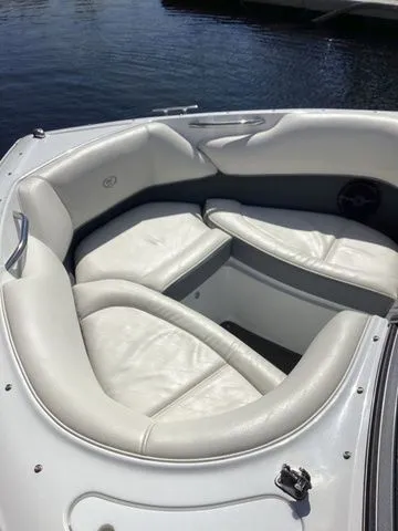 Slide: The Image of 2016 Cobalt 200S boat with white leather seating, docked on calm water. - 4