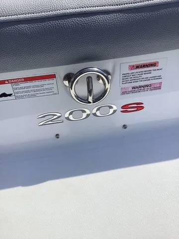 Slide: The Image of 2016 Cobalt 200S boat emblem with warning labels and chrome handle. - 8