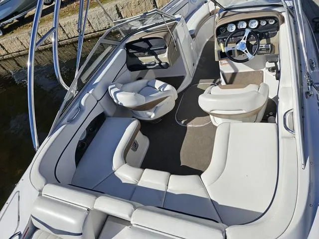 Slide: The Image of 2007 Four Winns Horizon 220 boat interior with white seating and modern dashboard. - 11