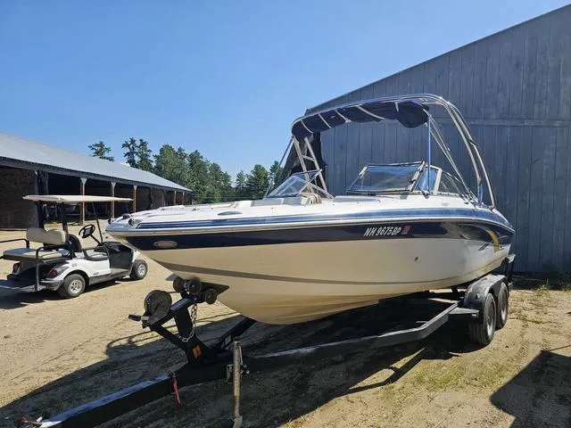 Slide: The Image of 2007 Four Winns Horizon 220 boat on trailer, parked outdoors near a barn. - 3