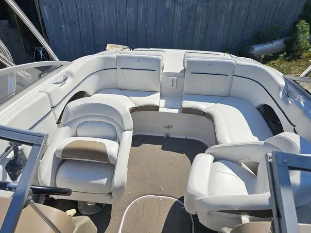 Slide: The Image of 2007 Four Winns Horizon 220 boat interior with white seating and spacious layout. - 6