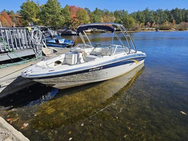Slide: The Image of 2007 Four Winns Horizon 220 boat docked on a serene lake with autumn foliage. - 7