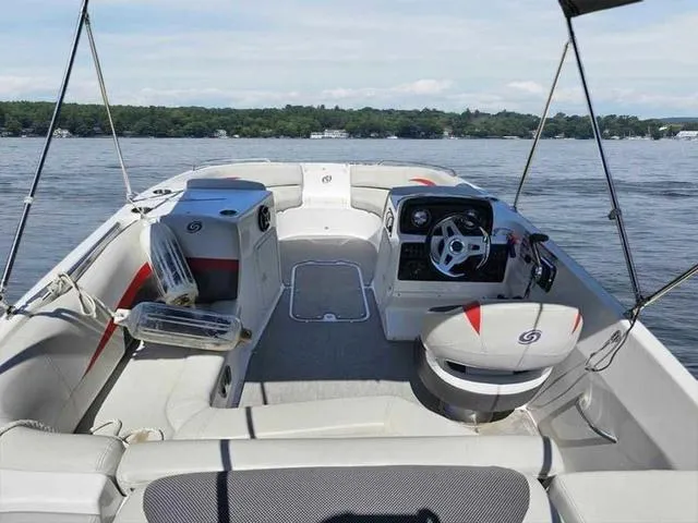 Slide: The Image of 2019 Hurricane 188 I/O boat interior with seating and steering, on a calm lake. - 10