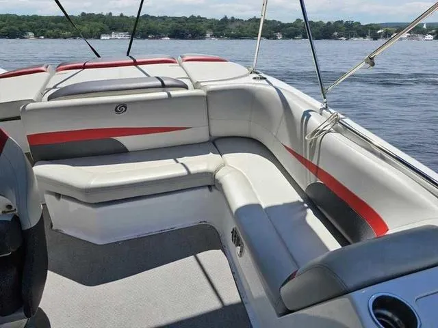 Slide: The Image of 2019 Hurricane 188 I/O boat interior with red and gray seating on a lake. - 3