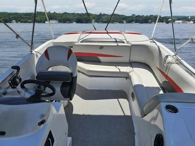 Slide: The Image of 2019 Hurricane 188 I/O boat interior with seating and steering wheel on a calm lake. - 4
