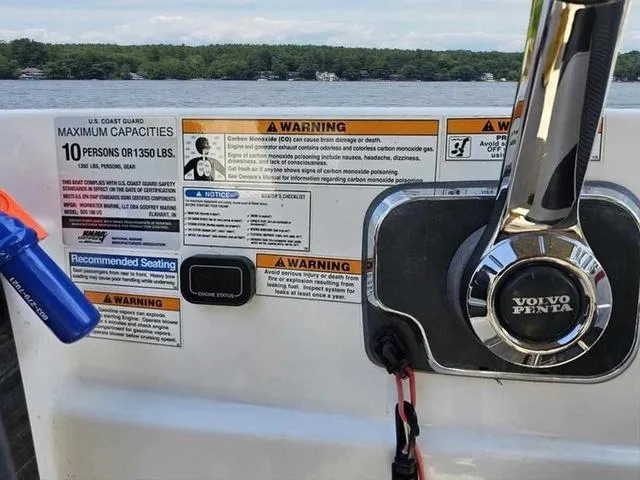 Slide: The Image of 2019 Hurricane 188 I/O boat dashboard with safety warnings and Volvo Penta controls. - 5