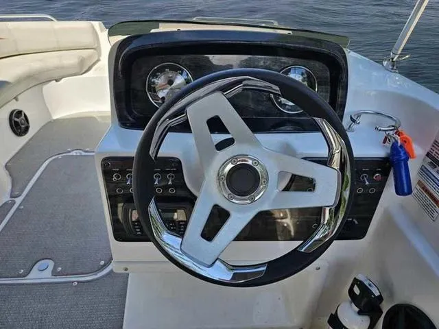 Slide: The Image of Steering wheel and dashboard of 2019 Hurricane 188 I/O boat, featuring modern controls. - 6