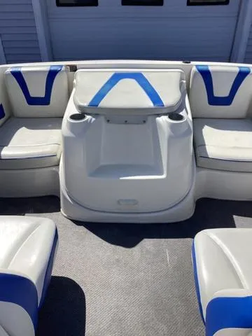 Slide: The Image of 2007 Bayliner HSP 190 boat interior with blue and white seating and cup holders. - 17
