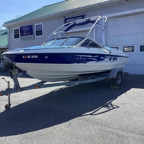 Slide: The Image of 2007 Bayliner HSP 190 boat on trailer outside a garage. - 21