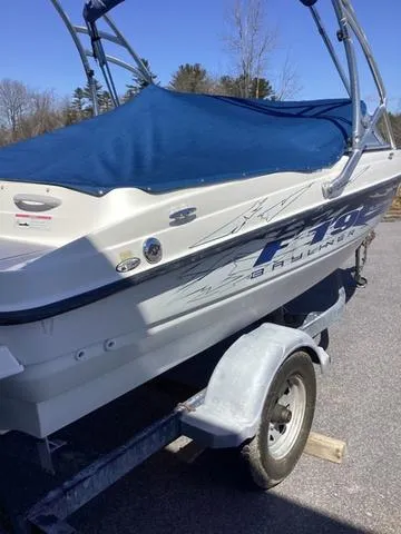 Slide: The Image of 2007 Bayliner HSP 190 boat on trailer with blue cover, parked outdoors. - 3